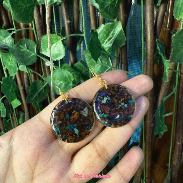 Close-up of resin drop earrings with preserved flowers