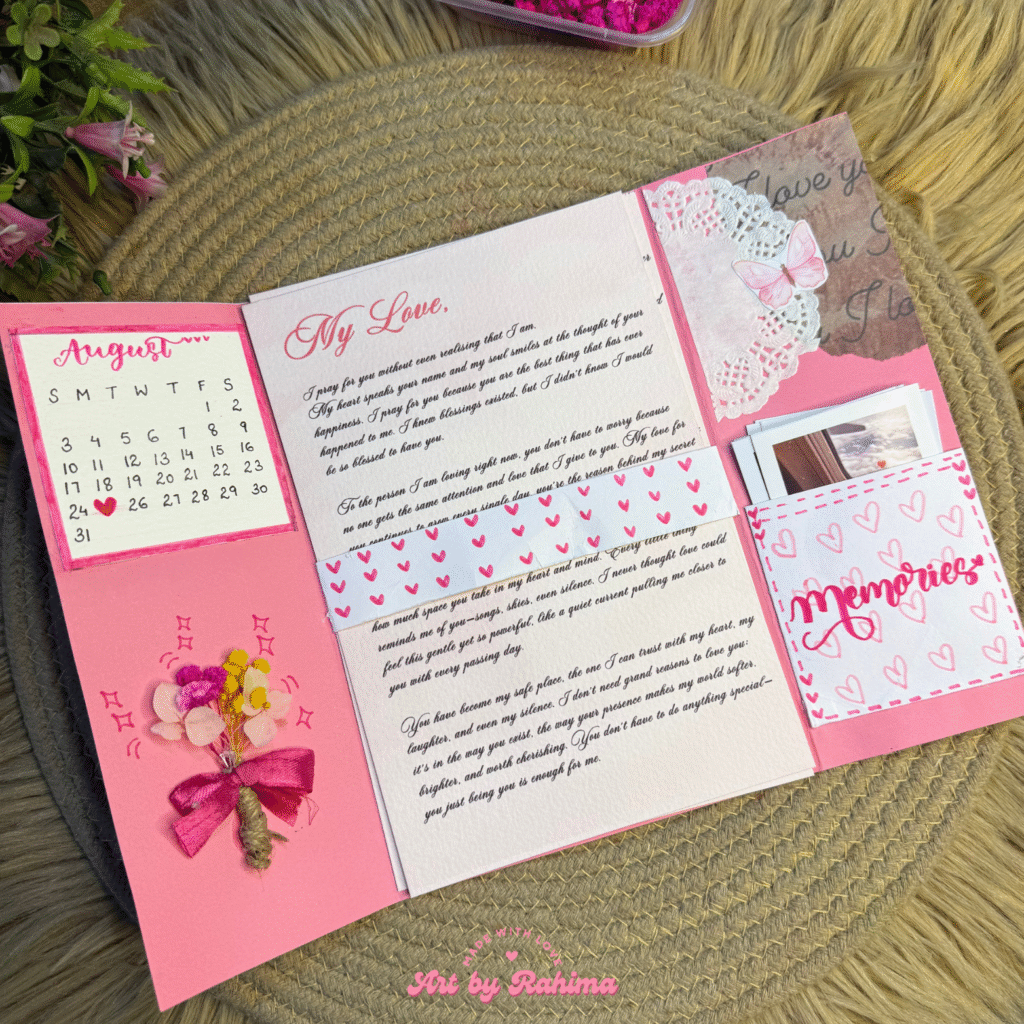 Open Pink Pookie flap card with printed letters, Polaroids, and calendar