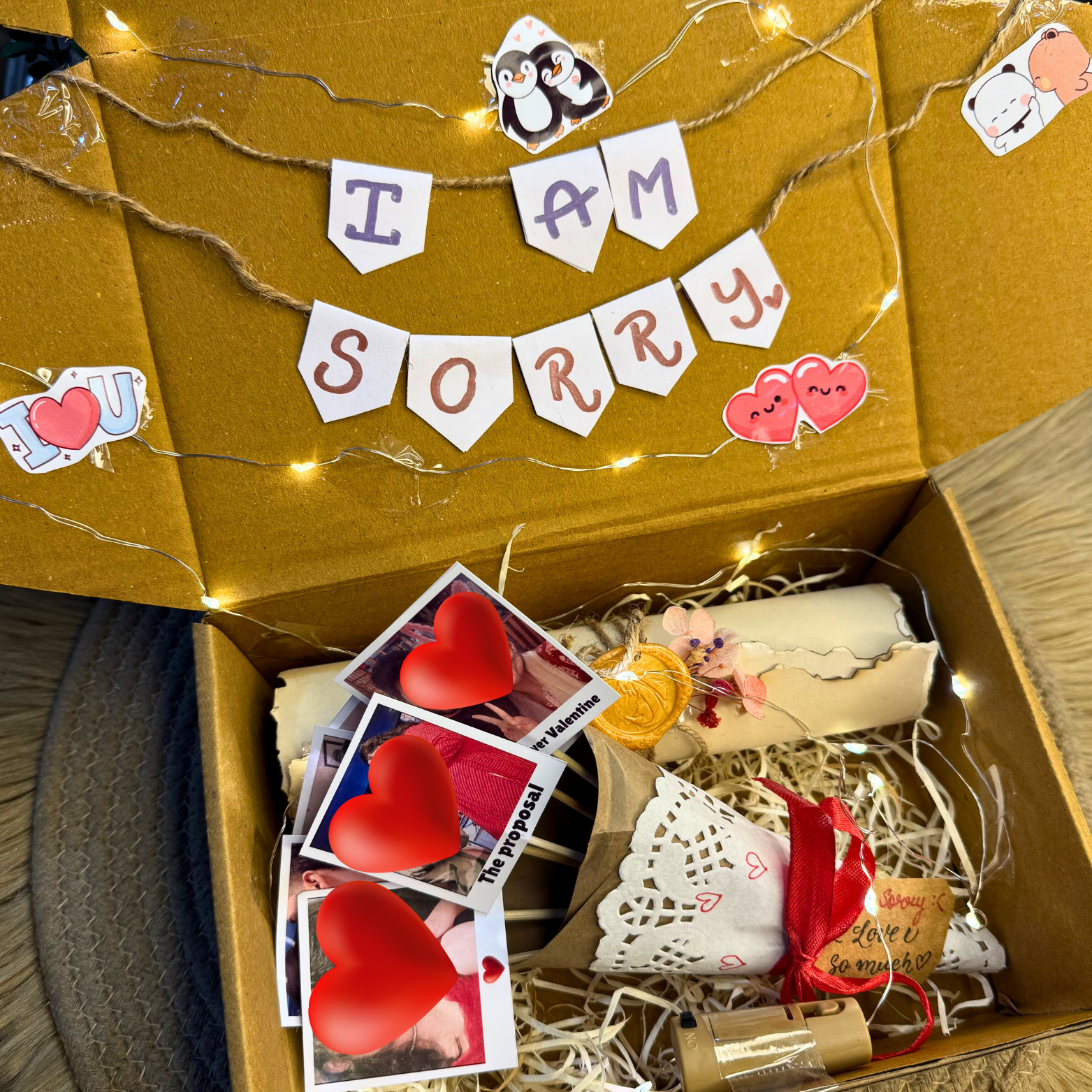 Decorated I’m Sorry Hamper with letter scroll, mini photo bouquet, and lights