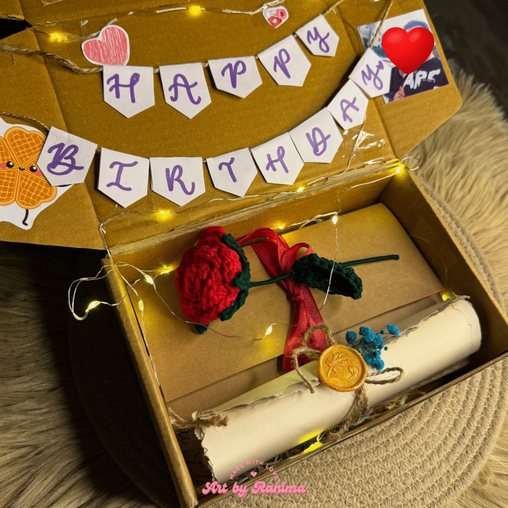 Handmade trifold card and handwritten letter scroll displayed in decorated hamper